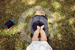 Little Baby Toddler Sitting On Mom Knees In Park