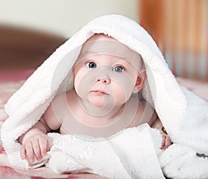 Little baby under white towel