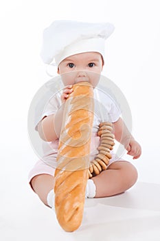 Little baker baby girl with a long loaf