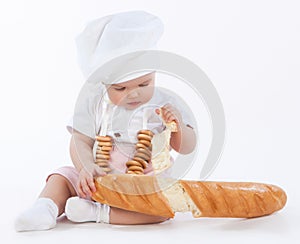 Little baker breaking off piece of bread