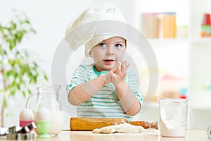 Little baker child girl in chef hat