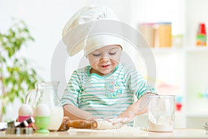 Little baker kid girl in chef hat