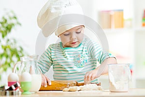 Little baker kid girl in chef hat