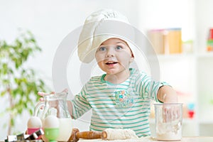 Little baker kid girl in chef hat