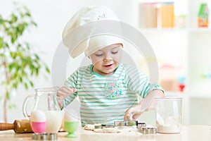 Little baker kid girl in chef hat