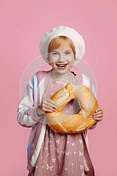 Little baker on pink background