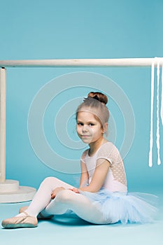 The little balerina dancer on blue background
