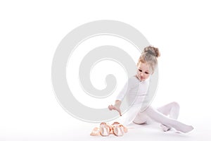 Little Ballerina and ballet shoes on a white background.