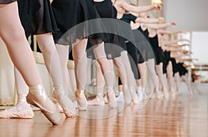 Little ballerinas doing exercises ballet class.