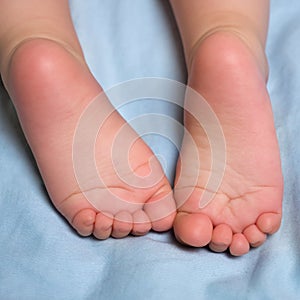 Little barefeet. Baby`s feet. Barefeeted baby. Children`s feet