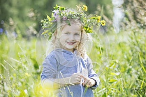 Little beautiful baby girl outdoors in a field in the fresh air