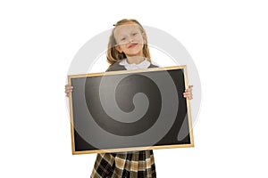 Little beautiful blond schoolgirl smiling happy and cheerful holding and showing small blank blackboard