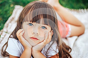 Little beautiful cute girl looking at camera blue eyes