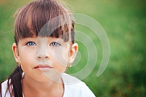 Little beautiful cute girl looking at camera blue eyes