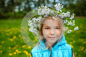 Little beautiful girl with floral wreath