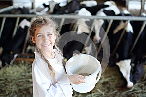 Little beautiful girl holds white bucket with food