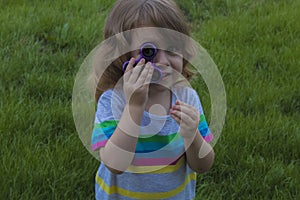 Little beautiful girl is playing blue spinner in hand.