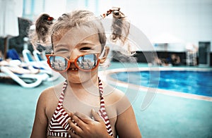 Little beautiful girl resting in the pool