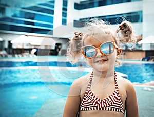 Little beautiful girl resting in the pool