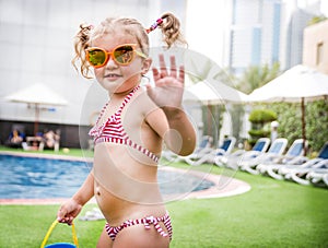 Little beautiful girl resting in the pool