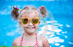 Little beautiful girl resting in the pool