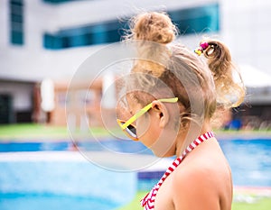 Little beautiful girl resting in the pool