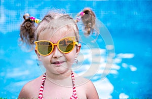 Little beautiful girl resting in the pool