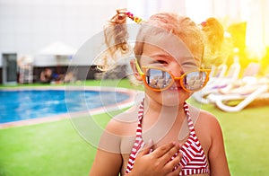 Little beautiful girl resting in the pool