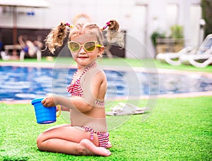 Little beautiful girl resting in the pool