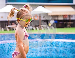 Little beautiful girl resting in the pool