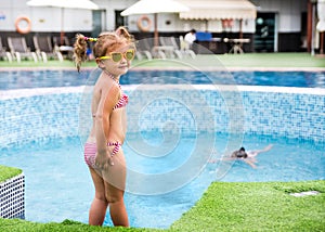 Little beautiful girl resting in the pool