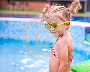 Little beautiful girl resting in the pool