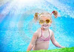 Little beautiful girl resting in the pool