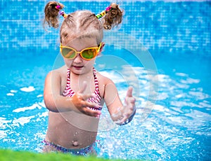 Little beautiful girl resting in the pool