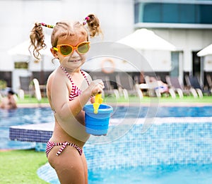 Little beautiful girl resting in the pool