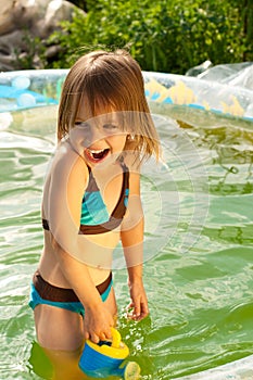Little beautiful girl in swimming pool.