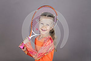 Little beautiful girl with a tennis racket