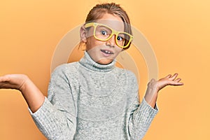 Little beautiful girl wearing casual clothes and yellow glasses celebrating achievement with happy smile and winner expression