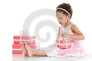 Little beautiful mulatto girl with a gift in their hands