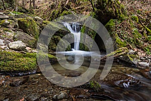 little beautiful waterfall with a stonestage an moss