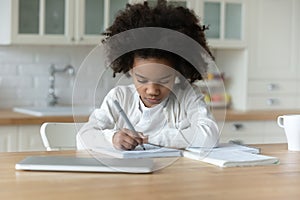 Little biracial girl study at home on quarantine