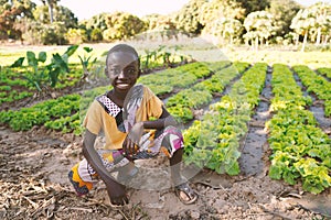 Little Black African Boy Child Smiling in front of Agricultural Camp in Bamako, Mali