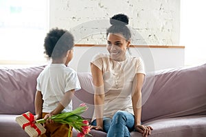 Little black boy preparing surprise for mommy on Mothers Day