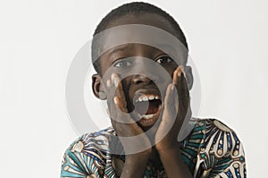 Little black boy surprised and excited with white isolated background