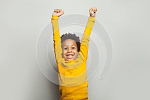 Little black child win-win! Kid boy having fun on white background