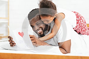 Little black girl celebrating Father`s Day with daddy