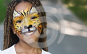 Little black girl with tiger face painting