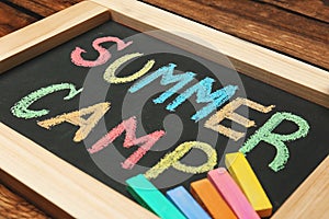 Little blackboard with text SUMMER CAMP chalked