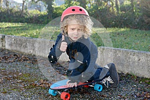 Little blond boy with skateboard