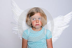 Little blond girl with angel- wings